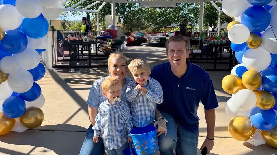 Family poses for picture in entrance to pavilion